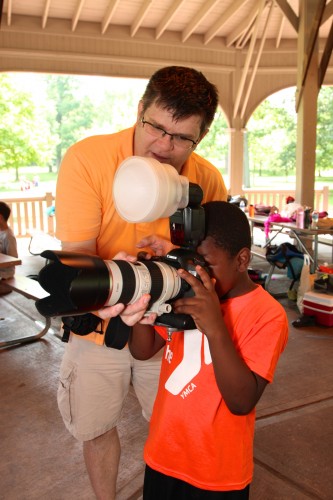 Ken showing a camper how his camera works at Camp Thunderbird, Rochester NY.