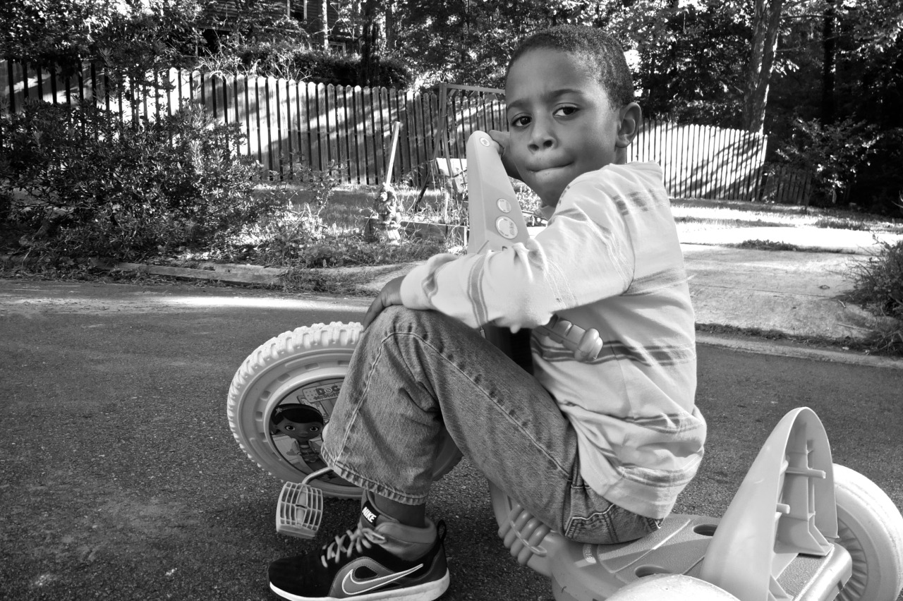 small african-american boy on tricycle