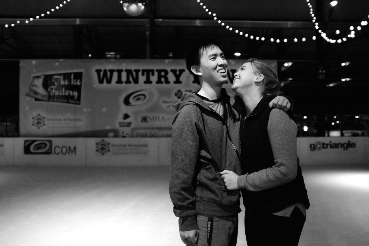 young boy and girl at ice rink laughing