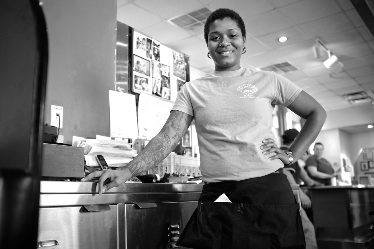 Black and White photo of a young african-american waitress at a restaurant