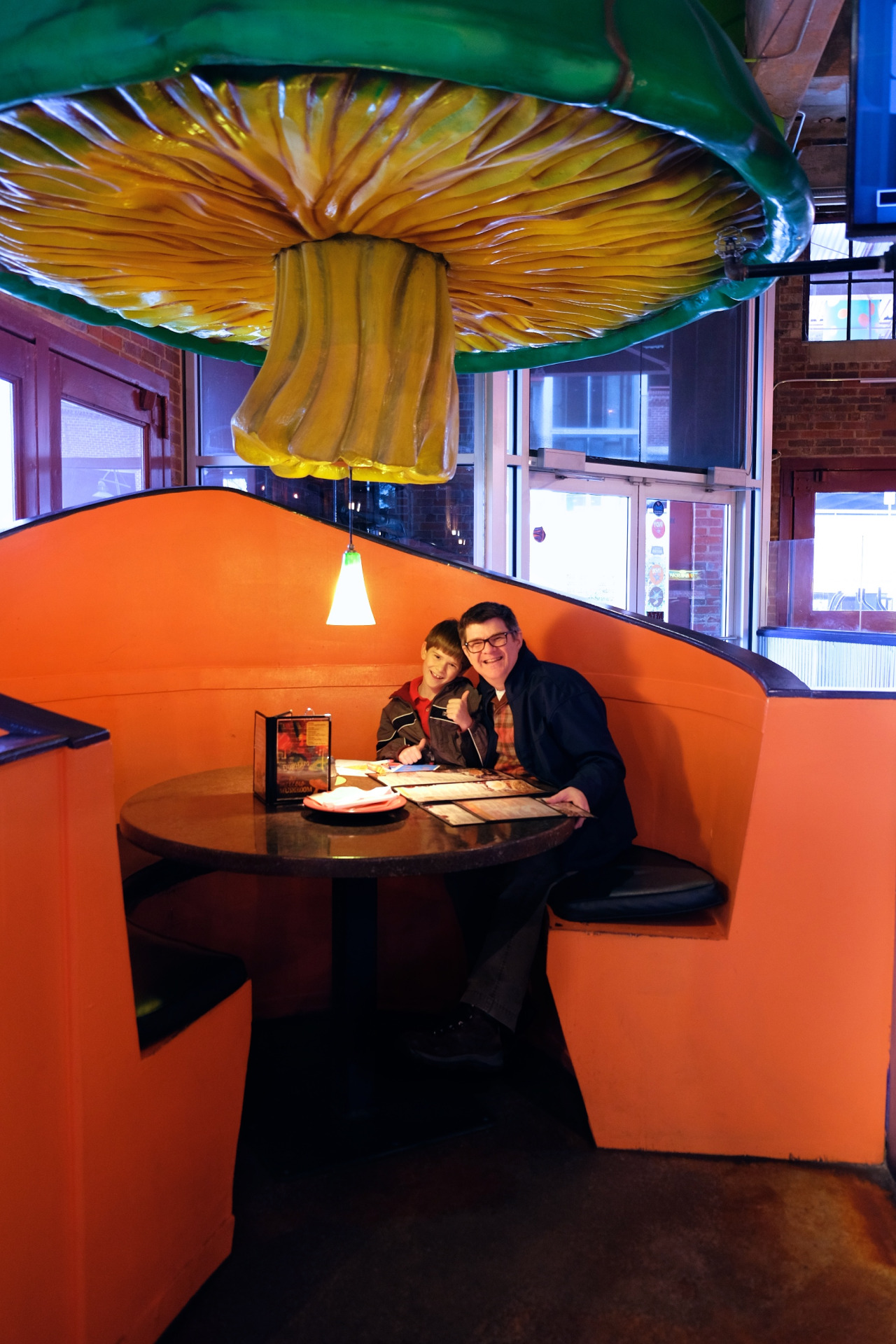 photo of a father and son in the Mellow Mushroom 'Mushroom Booth'