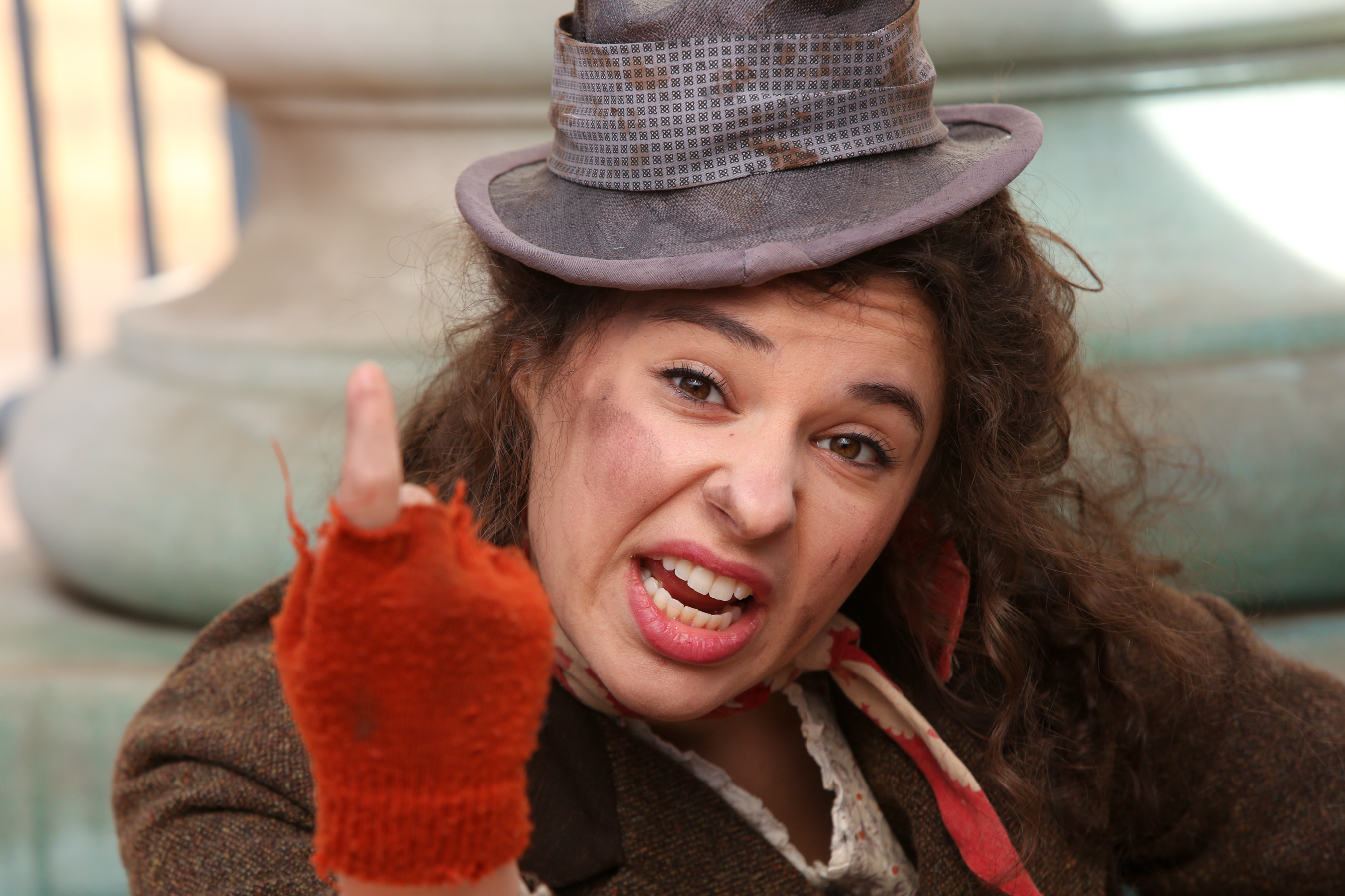 actor Mia Pinero as Eliza shouting at someone