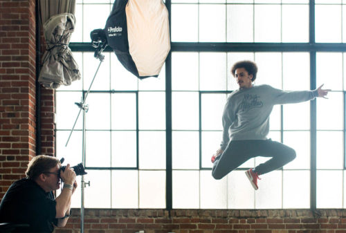 Photo of a Creative Live Class with photographer using a studio light to capture a dancer in the air