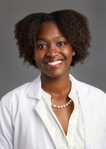 woman with a gray background behind her