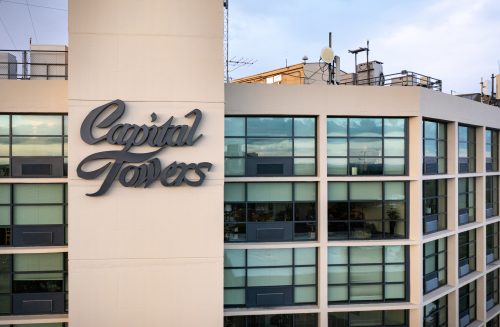 close-up view of the top of a building with name "Capital Towers"