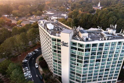aerial photo of Capital Towers building by drone with trees surrounding