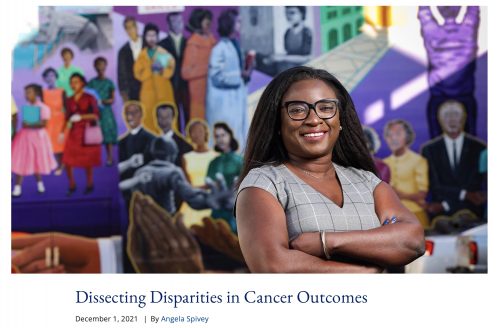 photo of a confident black woman with a colorful civil rights mural behind her