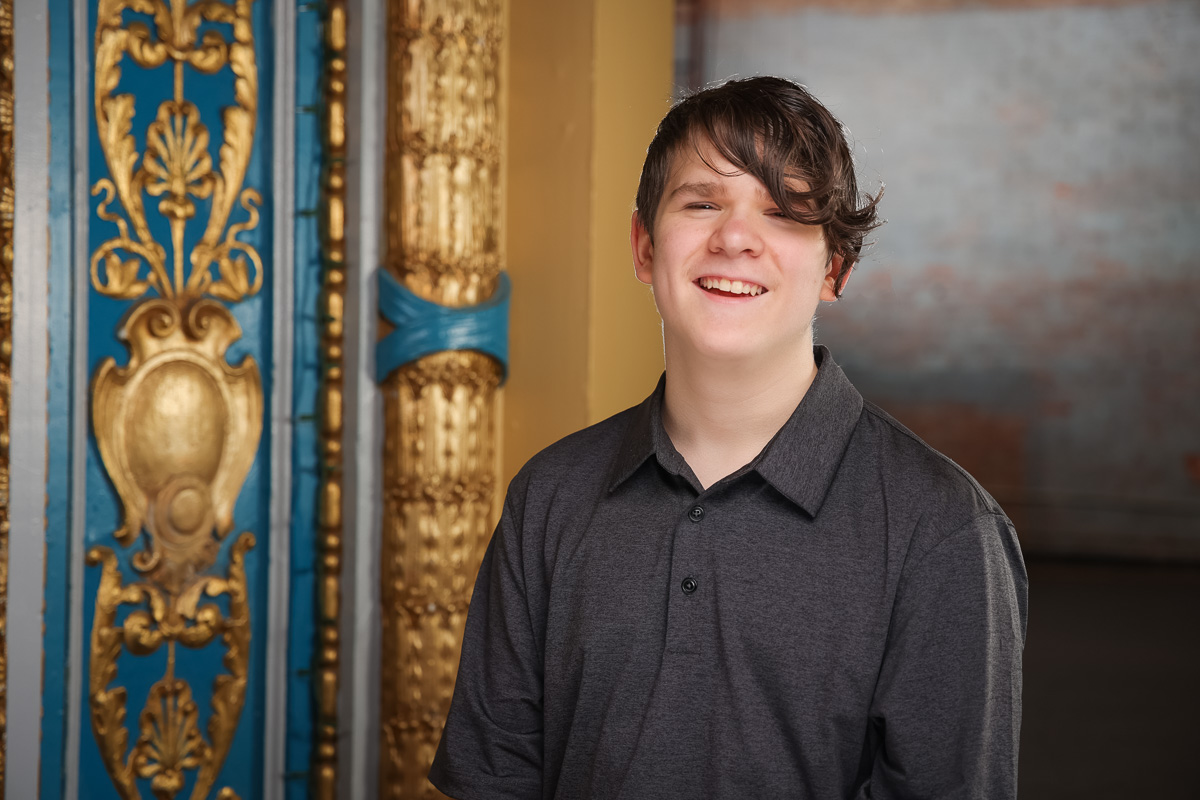 teen boy smiling in a colorful stage are