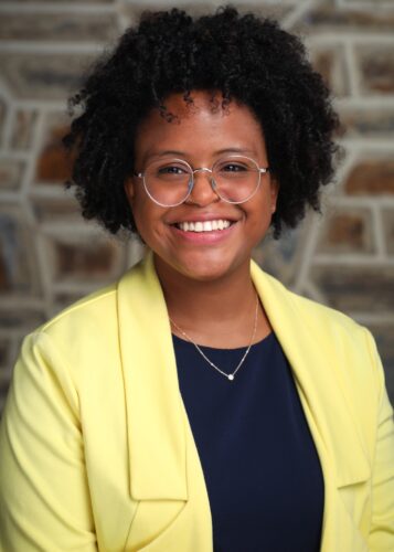 portrait of a woman smiling at the camera with a nice Duke Stone background