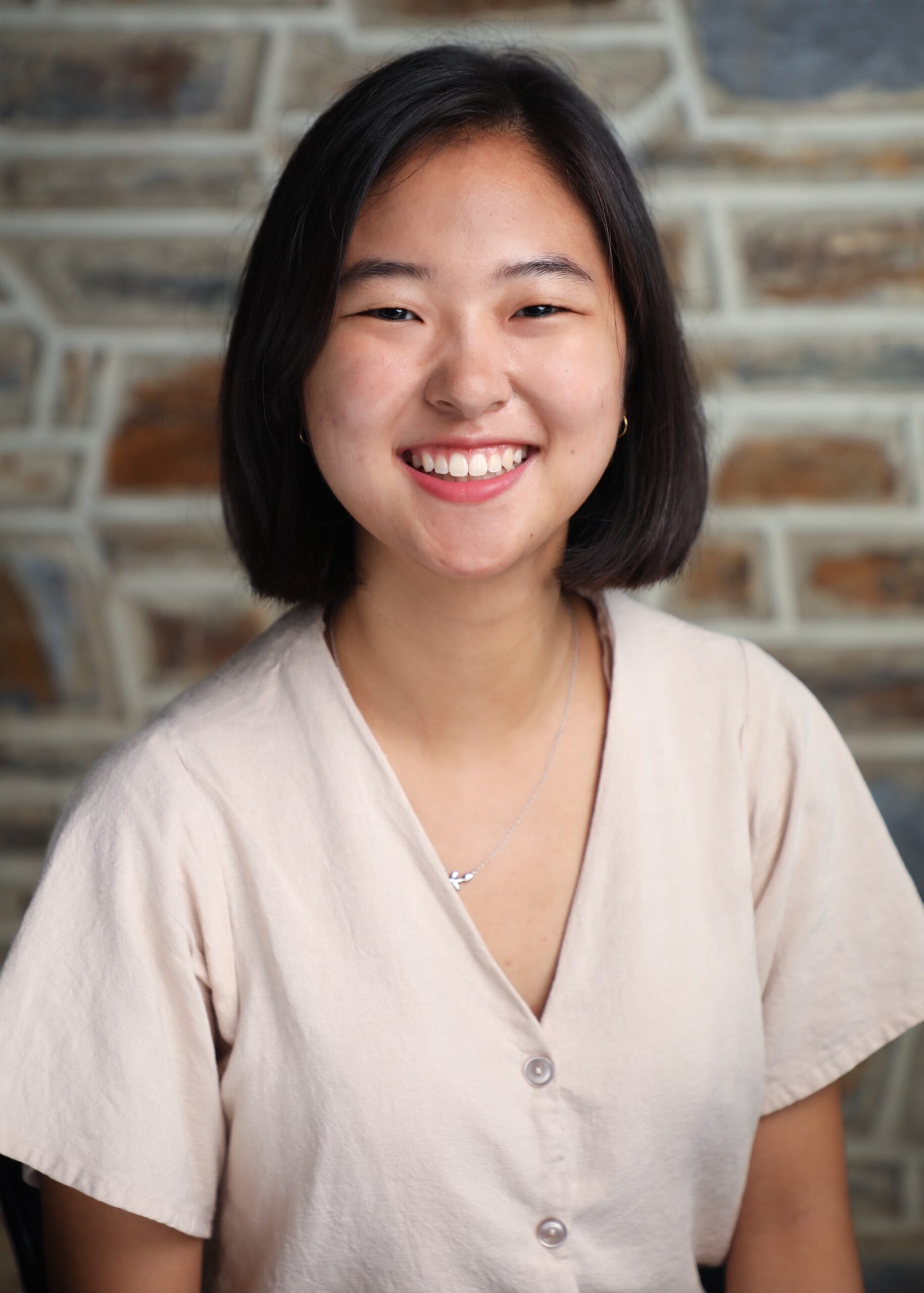 portrait of a woman smiling at the camera with a nice Duke Stone background