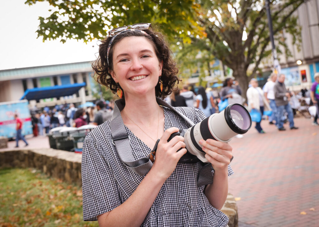 female photographer with camera outdoors pictured: Erin Scannell