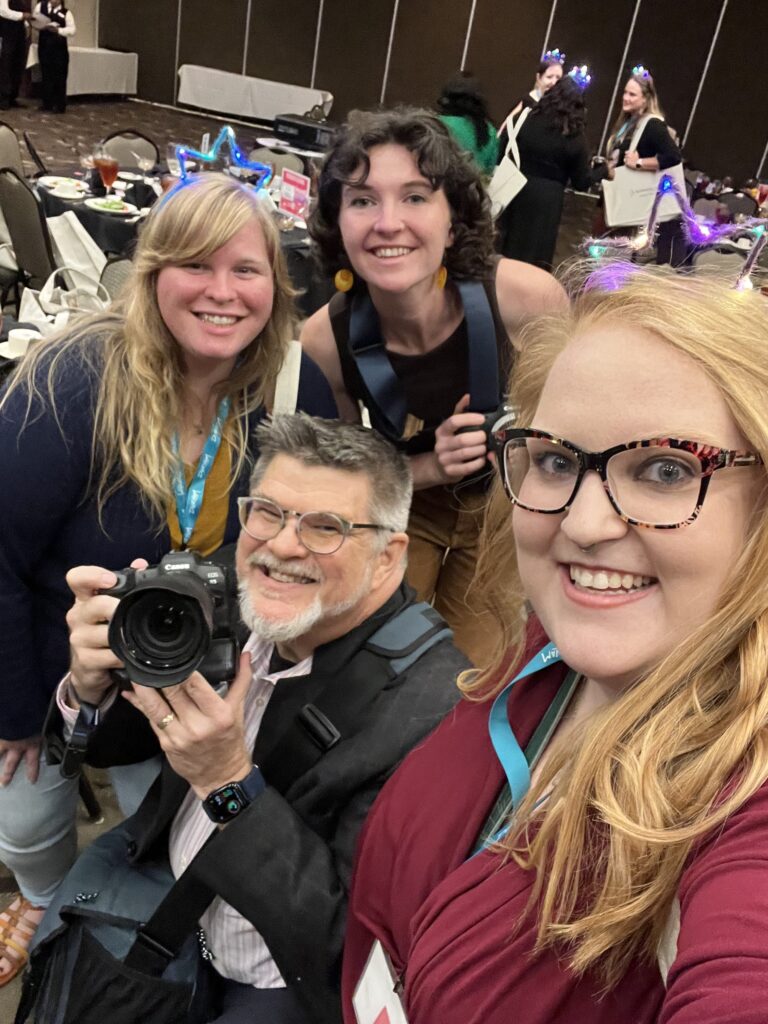 some of the women Team members of HuthPhoto pose with Ken Huth. Lizzie Potter, Erin Scannell are in the image with a former employee Camille