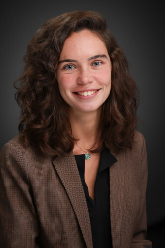 studio portrait of a young professional woman smiling at the camera